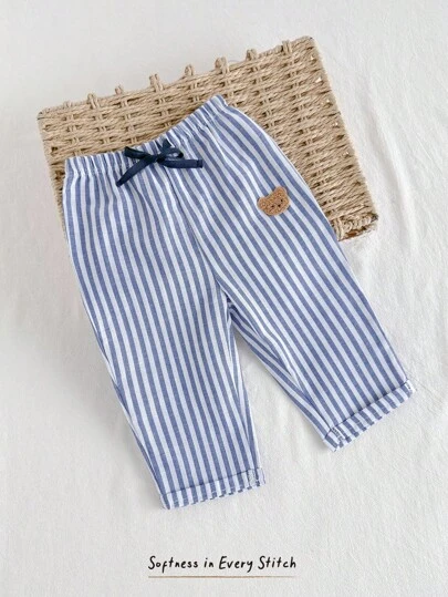 Cozy Pixies Babypojke med resår i midjan och avslappnade långbyxor med dekorativt band, bekväma och mångsidiga