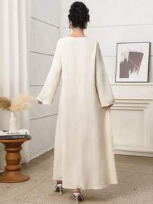 Al Najma Elegant Yellow Modest Abaya Dress For Women, Featuring A Unique Round Neckline With Pearl Beaded Cut-Out Details. This Long Sleeve Woven Fabric Gown, With Its Semi-Sheer And Subtle Rib-Knit Texture, Offers Grace And Style. Kaftan Jalabiya Dress - Yellow - View 3