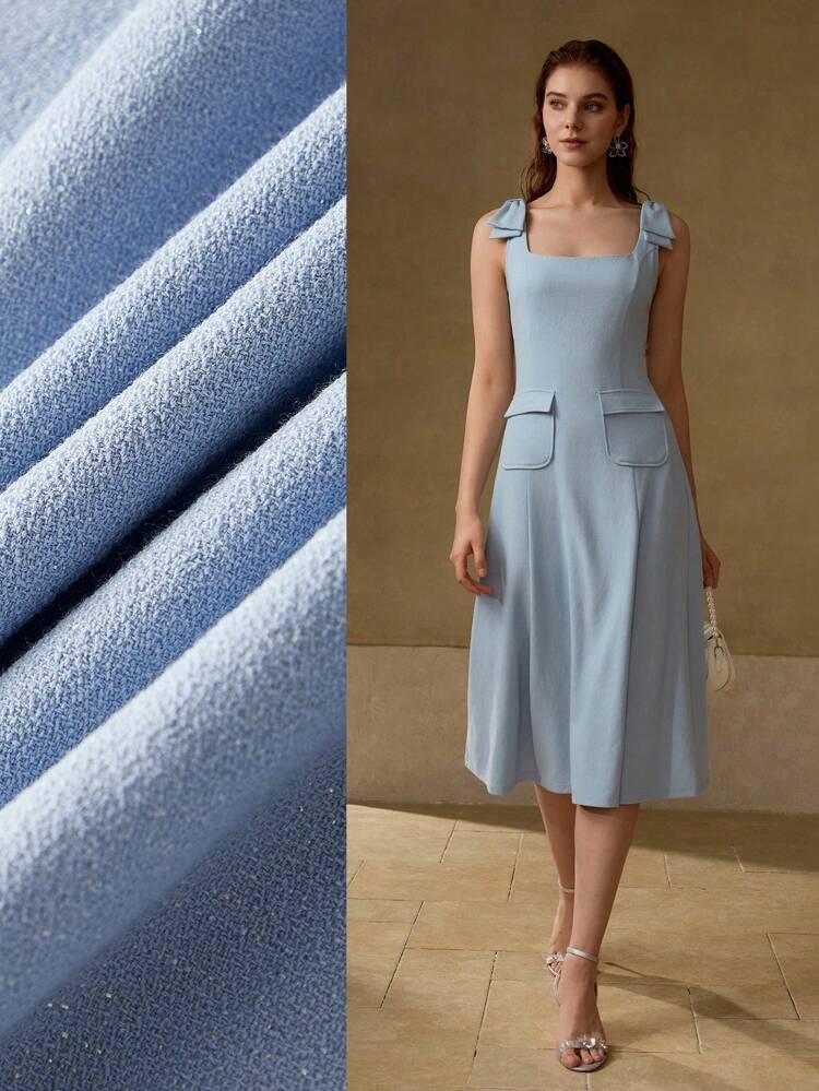 Abito con fiocco sulle spalle, tasche con patta, orlo ampio e fluente