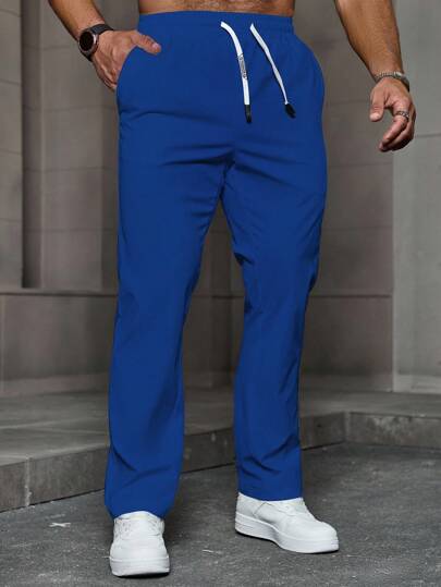 Manfinity Homme Pantalones casuales con cordón en la cintura y bolsillos, pantalones largos clásicos de color azul real lisos de tela tejida para hombre con estilo empresarial, pantalones de chándal versátiles azul real para hombre, pantalones deportivos con cordón para hombre, pantalones rectos de chándal azul real para hombre, otoño