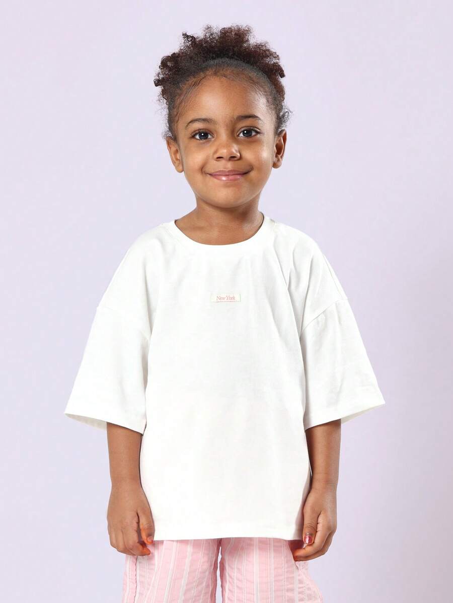 SUMWON Mädchen Oversize T-Shirt aus Baumwoll Jersey, legeres Kurzarm Oberteil mit Stadt Muster, Logo in Rosa, Basic Sommer Wochenend T-Shirt mit Rundhalsausschnitt - Weiss - Übersicht 1
