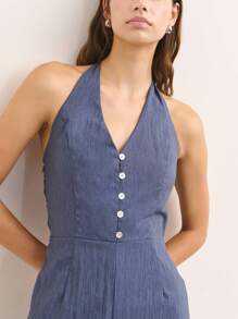 Nöista Open-Back Jumpsuit In Brown With Shoulder Straps And A Figure-Hugging Fit. This Modern And Versatile Design Is Perfect For Casual Events Or Night Outs During Spring, Summer, Or Fall. Easily Styled With Sandals, Heels, Or Sneakers For A Sexy And Elegant Look. - Blue - View 3