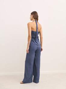Nöista Open-Back Jumpsuit In Brown With Shoulder Straps And A Figure-Hugging Fit. This Modern And Versatile Design Is Perfect For Casual Events Or Night Outs During Spring, Summer, Or Fall. Easily Styled With Sandals, Heels, Or Sneakers For A Sexy And Elegant Look. - Blue - View 2