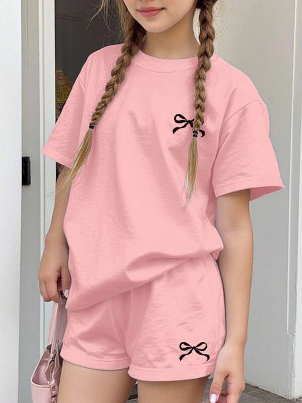 SHEIN Teen Girls Casual Minimalist Bow Decor Round Neck Short Sleeve T-Shirt And Shorts 2pc Set, Suitable For Spring/Summer Girls Tshirt With Bows Teen Girls Pink Short Set Girls Pink Oversized Tshirt Short Set Girls Bows Print Tee And Shorts Set Girls Casual Pink Short Sleeve Set