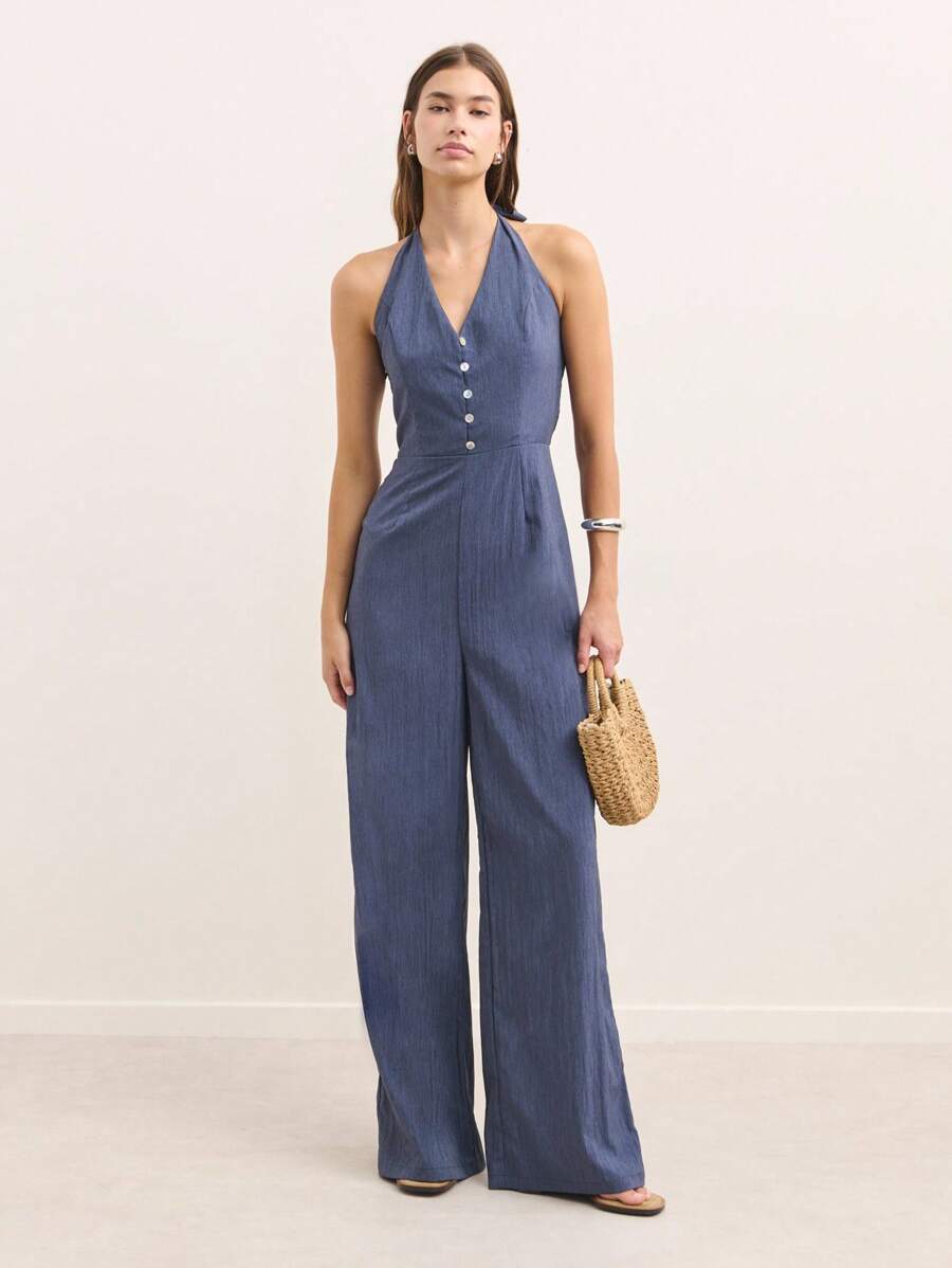 Nöista Open-Back Jumpsuit In Brown With Shoulder Straps And A Figure-Hugging Fit. This Modern And Versatile Design Is Perfect For Casual Events Or Night Outs During Spring, Summer, Or Fall. Easily Styled With Sandals, Heels, Or Sneakers For A Sexy And Elegant Look. - Blue - View 1