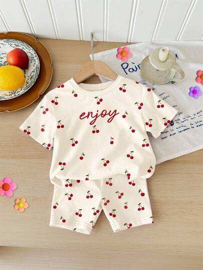 SHEIN Cream White, Cute Mini Cherry Simple Sweet Letter Pattern, Baby Girl Casual Loose Round Neck Short Sleeve T-Shirt And Shorts Set, Suitable For Home, Outing, Street Shooting, Picnic, Outdoor, Vacation, Back To School, Summer Outfits For, Easy Comfort, Autumn Layers For Baby Girl, Stylish Baby Girl, Casual Wear, Baby Girl Graphic Clothes, Back To School, Fall Cloth Cherry Baby Outfit Baby Clothes Set Summer Summer Baby Pajamas Baby Casual Sets Cherry Print Baby Outfit