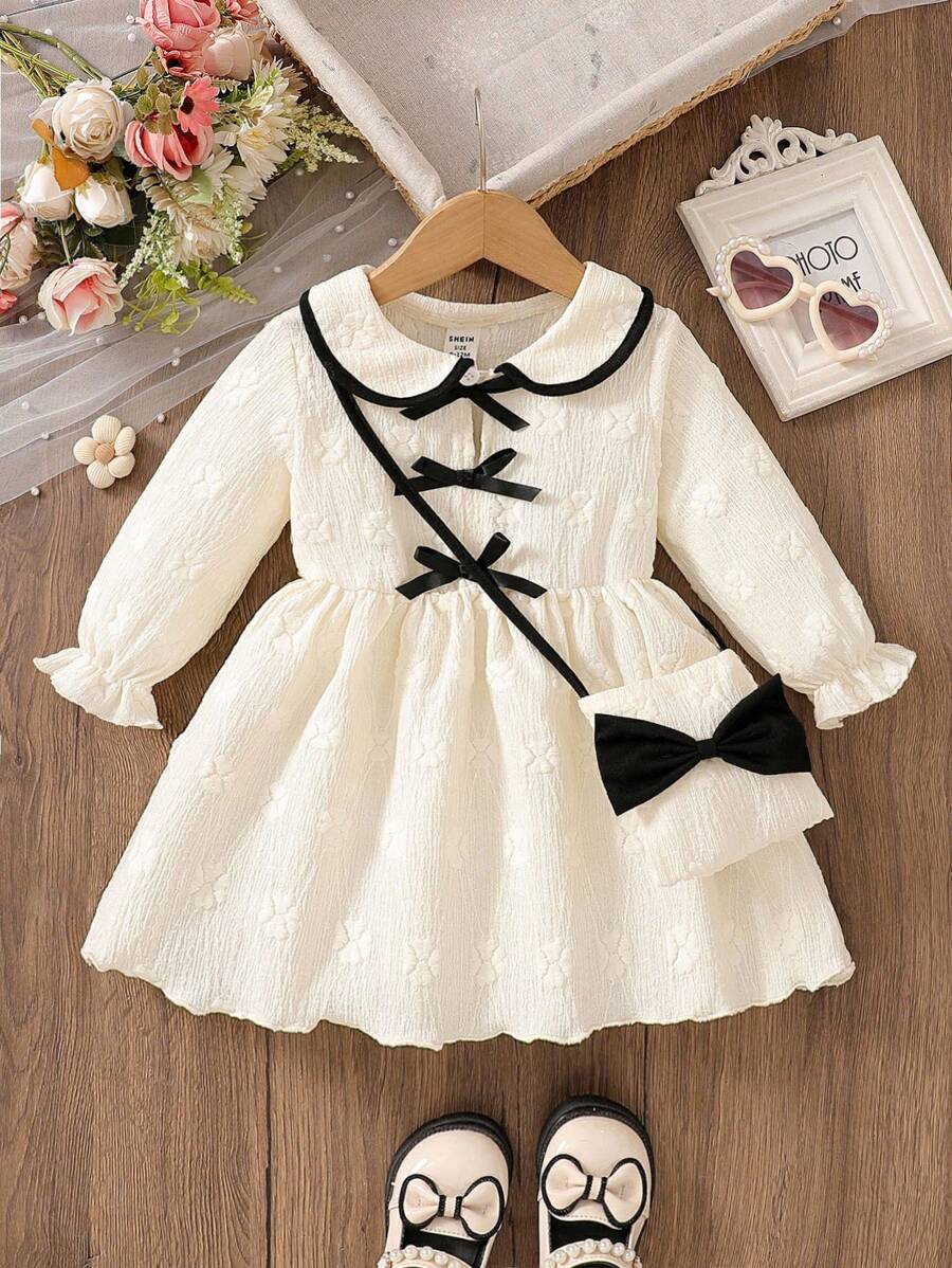 SHEIN 女婴优雅简约彼得潘领杏色连衣裙，饰有黑色对比蝴蝶结，配同款手提包，适合秋冬季节穿着 - 杏色 - 查看 1