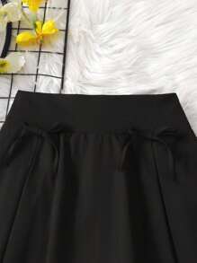 Tween Mädchen Mini-Rock in Schwarz mit Schleife, plissierter Rock mit eingebauter Sicherheitsshorts, Alltagskleidung, Lässig-Anlässe, Rückkehr zur Schule