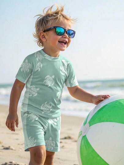 SHEIN Young Boy Casual Cute Cartoon Turtle Print Snug Fit Round Neck Short Sleeve T-Shirt & Tight Shorts Swimming Suit, Suitable For Summer