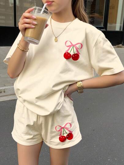 SHEIN 2PCS Set Cute Cherry Butterfly Print Cream White Loose Casual Round Neck Short Sleeve T-Shirt And Shorts, For Teen Girls, Suitable For Spring/Summer, Back To School, 2000s Style, Y2K, Chill Summer, Vacation Vibes Cherry Two Piece Set For Girl Cherry Kids Outfit Teen Girl Summer Short Sets Girls Cherry Shorts Set Cherry Print Two Piece Set