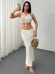 SHEIN Conjunto de 2 piezas de punto a ganchillo hecho a mano estilo boho para vacaciones, que incluye top con cuello de halter calado y flecos y una falda larga calada con cordón en unicolor