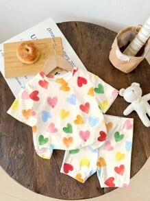 SHEIN Bộ 2 món/Bộ áo thun tay ngắn và quần short in hình trái tim nhiều màu sắc màu trắng kem dễ thương cho bé gái, kỳ nghỉ hè, cảm giác nghỉ dưỡng, họa tiết hoa cổ điển, màu pastel hoàng hôn, thư giãn - Nhiều màu - Xem 2