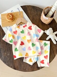 SHEIN Bộ 2 món/Bộ áo thun tay ngắn và quần short in hình trái tim nhiều màu sắc màu trắng kem dễ thương cho bé gái, kỳ nghỉ hè, cảm giác nghỉ dưỡng, họa tiết hoa cổ điển, màu pastel hoàng hôn, thư giãn - Nhiều màu - Xem 4