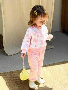 SHEIN 这款女宝宝时尚、可爱、甜美、活泼、俏皮、优雅，粉色蝴蝶结，波点圆领，长袖拼接，黑色菌褶边上衣和黑色菌褶边装饰，搭配喇叭长裤，适合日常居家外出、购物、运动、校园露营、野餐等秋冬季穿着。 - 粉色 - 查看 8