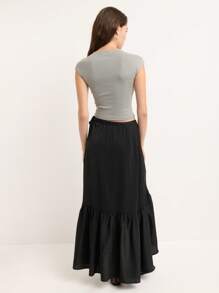 Nöista This Black Maxi Skirt Features An Asymmetrical Wrap Design With A Side Tie And Subtle Ruffle Hem, Blending Vintage Elegance With Y2K Streetwear Vibes, Perfect For Fall And Winter Women's Fashion.