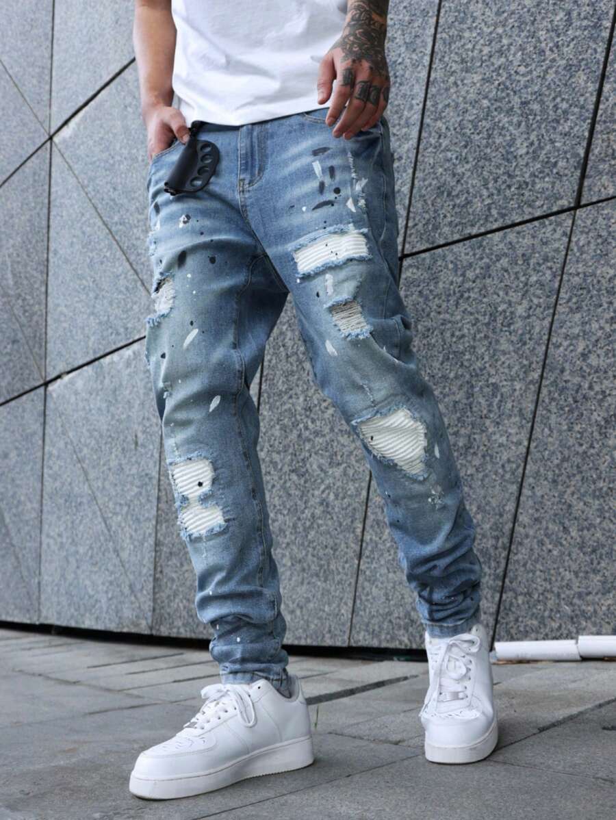 Manfinity EMRG Avant-Garde Gothic Style Long Ripped Jeans In Light Wash Denim For Men Men Paint Splatter Jeans Streetwear Jeans Ripped Jeans Men, Emo Style - Light Wash - View 1