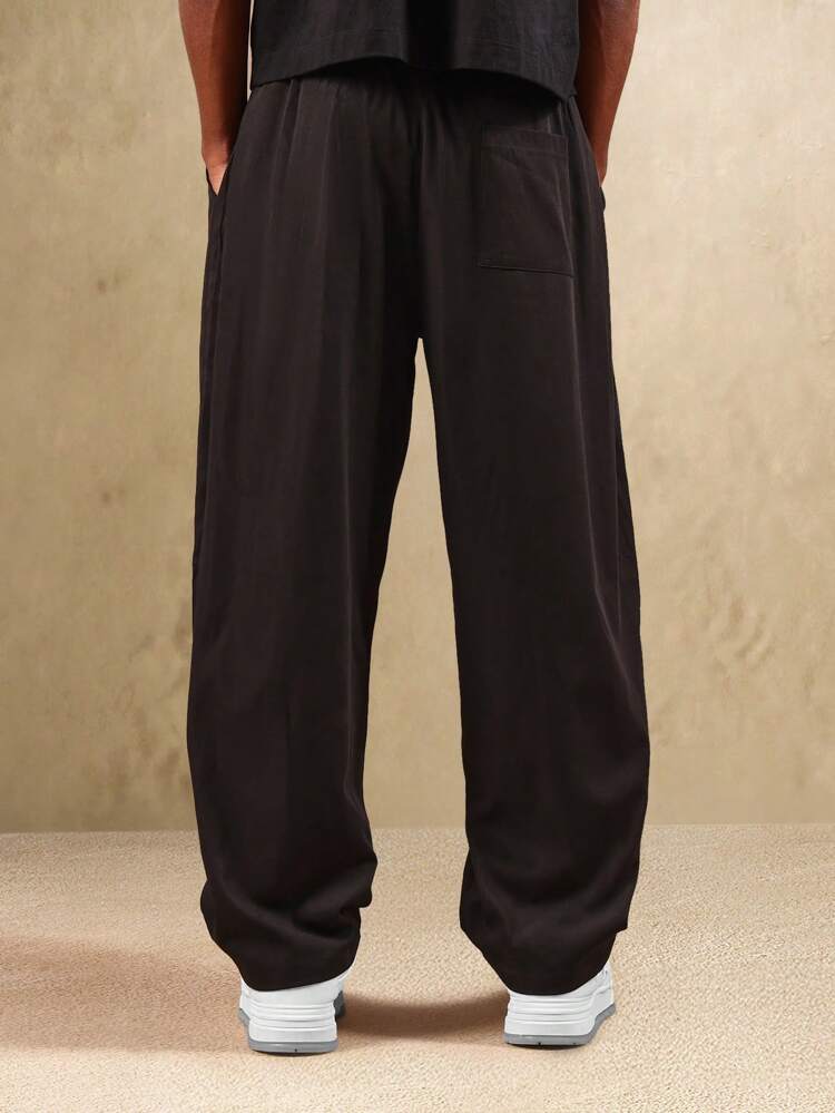 Pantalón de sarga plisado de pierna ancha con bolsillos laterales