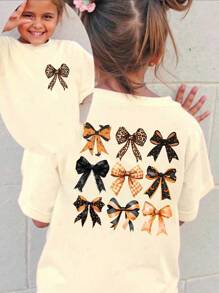 SHEIN Halloween Girls Toddler Yellow T-Shirt, Casual Fashion Creative Tic-Tac-Toe Leopard Plaid Bow Graphic Print Short Sleeve Tee, Holiday Casual Style Girls Bow Shirt Bow Shirt Girls Bows On Clothes Cute Bow Shirt Bow Clothes