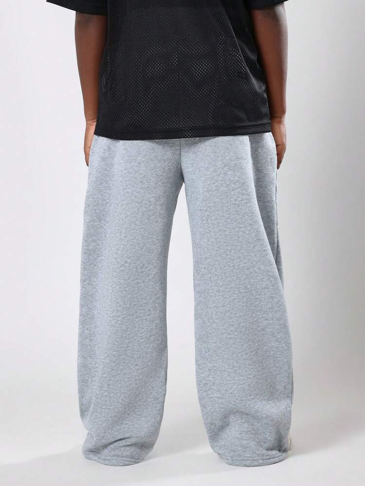 Pantalones deportivos anchos jaspeados con cintura con cordón