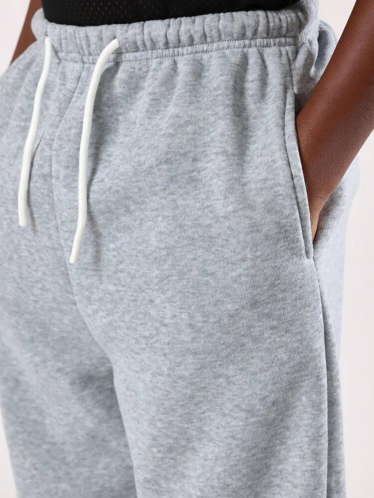 Pantalones deportivos anchos jaspeados con cintura con cordón