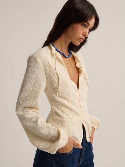 Nöista Textured Long-Sleeve Blouse With A Deep V-Neckline, Soft Gathered Sleeves And A Fitted Waist, Offering An Elegant And Feminine Silhouette Perfect For Winter Outfits, Polished Everyday Looks, Christmas Gatherings And Refined New Year Styling.