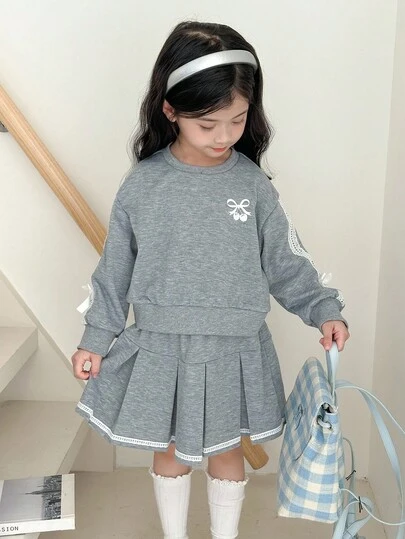 SHEIN Little Byeori Conjunto de sudadera con cuello redondo y mini falda con bordado de lazo para niñas jóvenes de estilo casual
