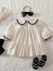 Souflis Souflis 女婴荷叶边领长袖A字裙，搭配薄纱蝴蝶结头饰。超大领口、泡泡袖和A字廓形，打造时尚经典造型。无论是外出还是居家休闲，小公主都能成为众人瞩目的焦点。 - 彩色 - 查看 3