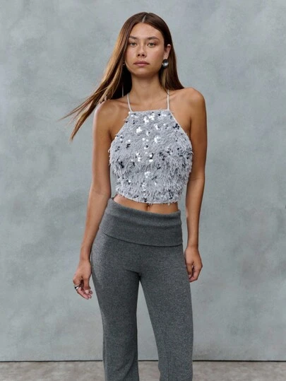TypaGal This Sparkly Halter Top Is All About Texture-Shaggy Faux Fur Covered In Sequins Gives It A Glam, Edgy Finish. A Night-Out Essential For Y2K Queens And 2000s Nostalgia Fans.