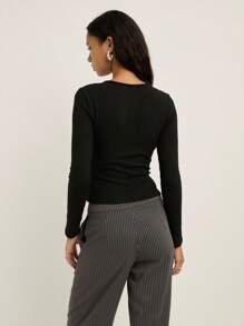 Nöista Ribbed Long-Sleeve Top With An Asymmetric Row Of Statement Buttons Running Down The Side, Designed With A Fitted Silhouette That Adds A Modern And Elegant Touch To Women's Winter Outfits, Perfect For Polished Everyday Looks, Christmas Gatherings And Refined New Year Styling. - Black - View 2