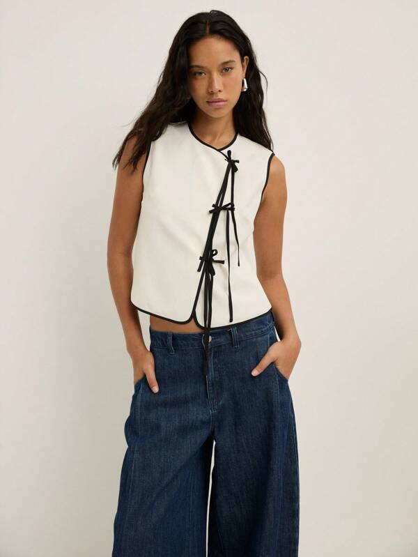 Nöista Camiseta sin mangas con cuello redondo y nudo delantero para mujer, adecuada para la oficina, vuelta al colegio, conciertos y estilo bohemio