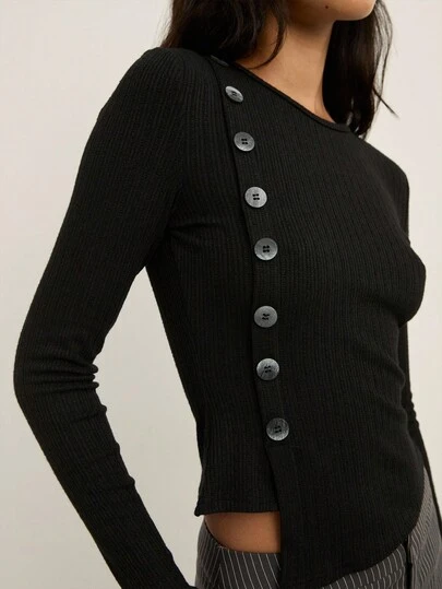 Nöista Ribbed Long-Sleeve Top With An Asymmetric Row Of Statement Buttons Running Down The Side, Designed With A Fitted Silhouette That Adds A Modern And Elegant Touch To Women's Winter Outfits, Perfect For Polished Everyday Looks, Christmas Gatherings And Refined New Year Styling.