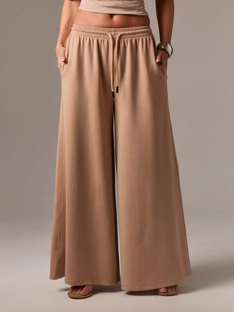 Pantalones palazzo de pierna ancha con cordón y bolsillos laterales