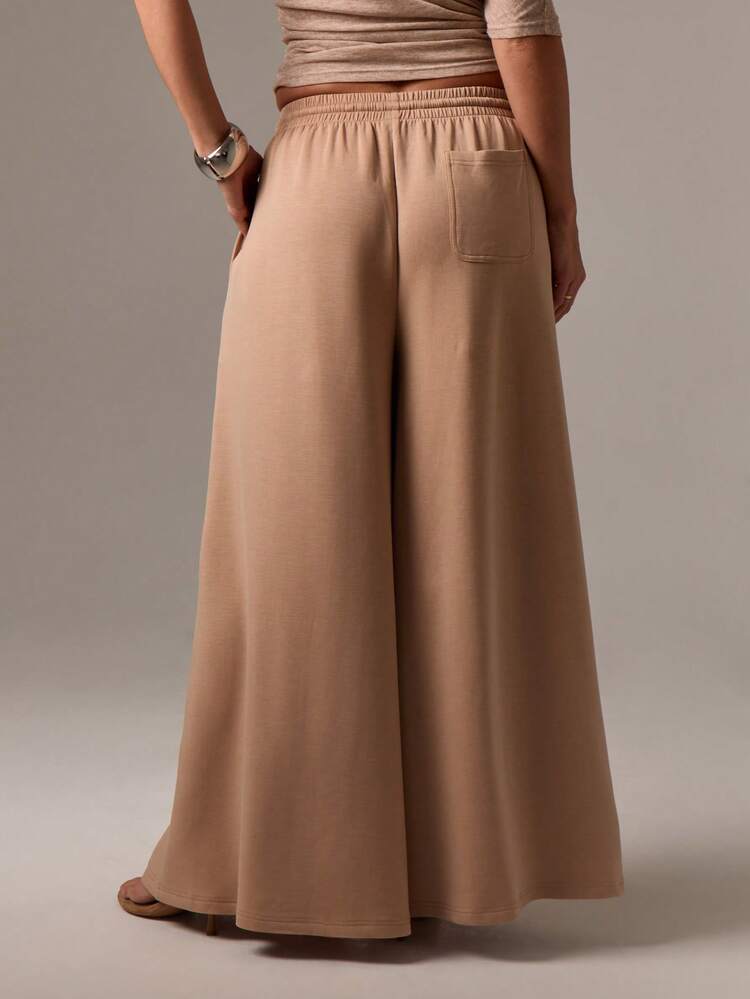 Pantalones palazzo de pierna ancha con cordón y bolsillos laterales