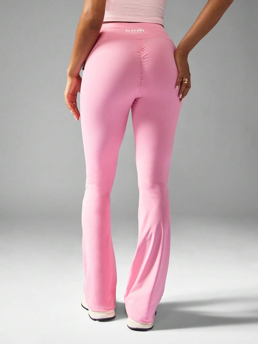 Missguided x Playboy Hoch sitzende ausgestellte Yoga Leggings mit geraffter Rückendetails, Cross-Back Sport-BH, Trainings-Hose für Studio-Praxis - Pink - Übersicht 1