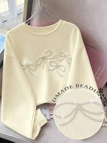 Resyla Áo nỉ cổ tròn dáng rộng có nơ đính hạt trang trí cho nữ - Màu be - Xem 1