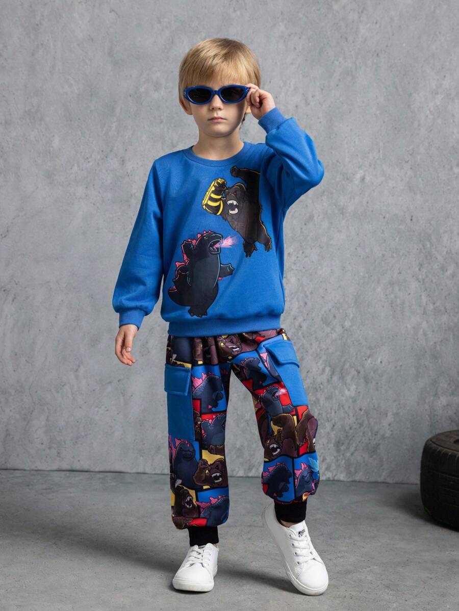GODZILLAxKONG X SHEIN Conjunto de sudadera de cuello redondo de punto con estampado gráfico de estilo y de King Kong para niño, y pantalones de chándal con bolsillo con solapa de estampado a cuadros de retazos de colores, para otoño/invierno