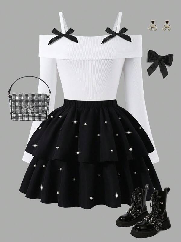 Sparklyn 少女时尚优雅T恤套装，白色针织上衣搭配黑色梭织蛋糕裙，上衣饰有黑色蝴蝶结，裙子点缀珍珠，适合秋冬季穿着。