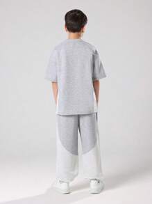 SUMWON Ensemble deux pièces pour pré-adolescents, Sweat-shirt-shirt gris chiné et jogging à larges jambes avec bloc de couleurs et imprimé logo orange. Tenue d'automne et d'hiver