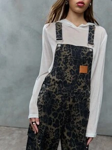 TypaGal These Wide-Leg Camo Print Overalls Add Wild Energy To Any Outfit. Layered Over A Sheer Hoodie, They Mix Utility And Attitude With Ease.