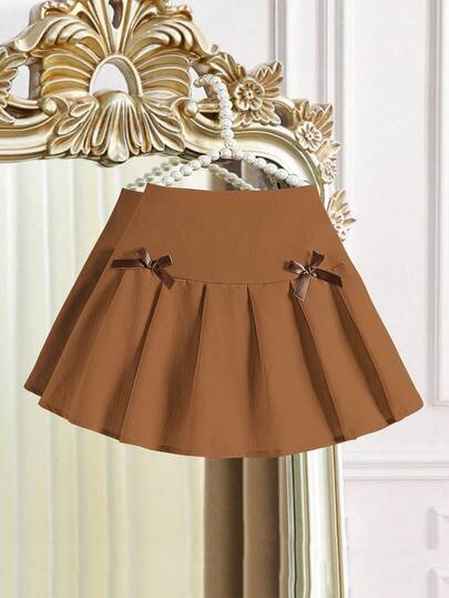 Falda plisada negra con decoración de lazo blanco para niñas preadolescentes, estilo casual y escolar para otoño e invierno