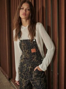 TypaGal These Wide-Leg Camo Print Overalls Add Wild Energy To Any Outfit. Layered Over A Sheer Hoodie, They Mix Utility And Attitude With Ease.