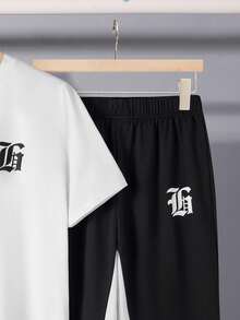 SHEIN Bộ 2 món/Bộ áo ngắn tay thường ngày và quần ống loe cho bé trai tuổi teen, trang phục phong cách trường học Punk Rock đường phố cho hàng ngày, tiệc tùng, lễ hội âm nhạc, thích hợp cho mùa xuân/hè, tương phản đen trắng theo phong cách Gothic Anh - Đen và trắng - Xem 6