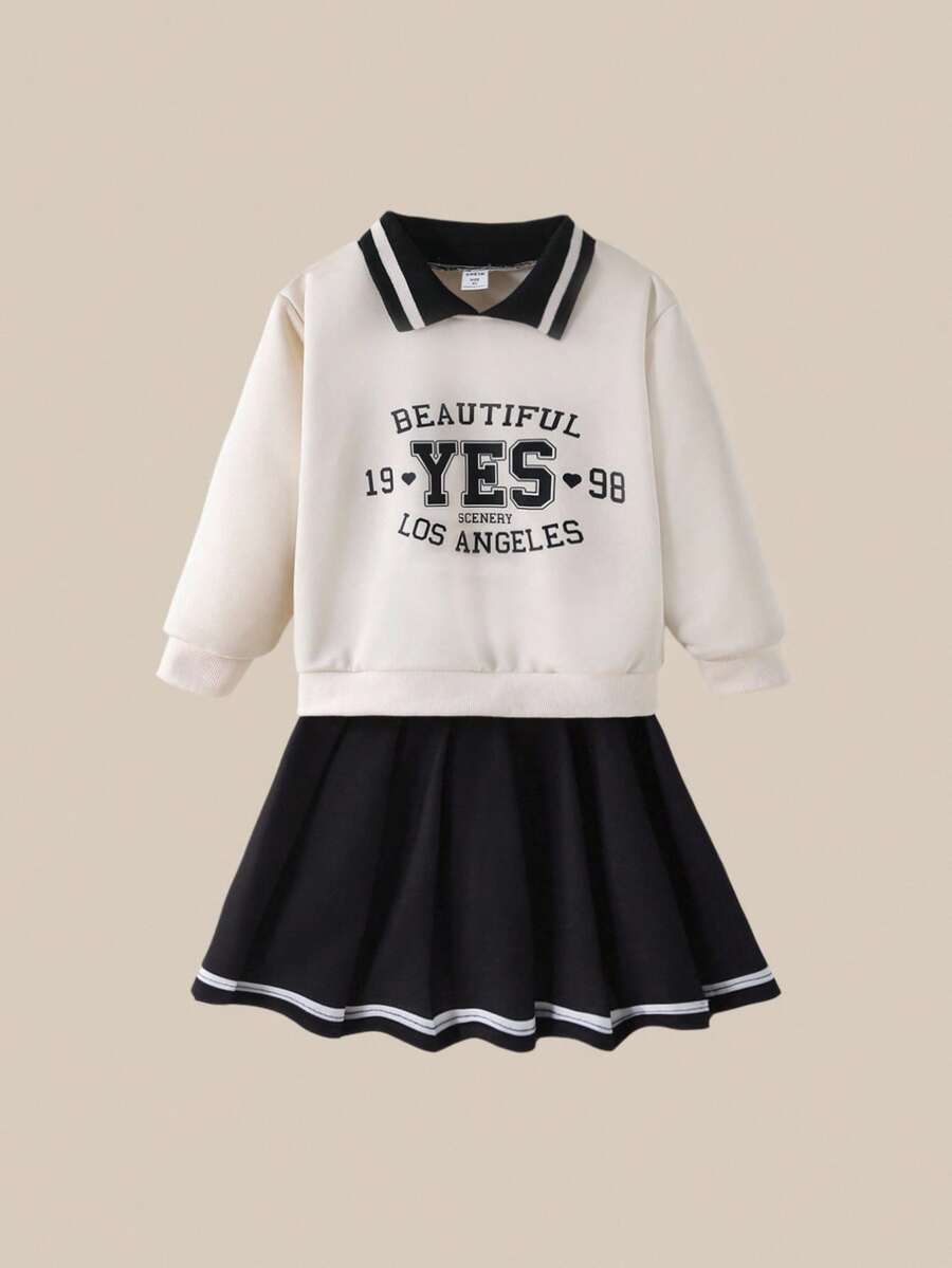 SHEIN Explorewe Conjunto de Suéter e Saia Casual Diário Simples para Meninas Jovens: Suéter de Cor Sólida com Estampa de Letra, Saia Curta. Um Conjunto Simples de Duas Peças de Cor Sólida para Meninas no Outono. Roupas Universitárias e Roupas Esportivas para o Campus na Temporada de Volta às Aulas 2025 - Preto - Visão 1