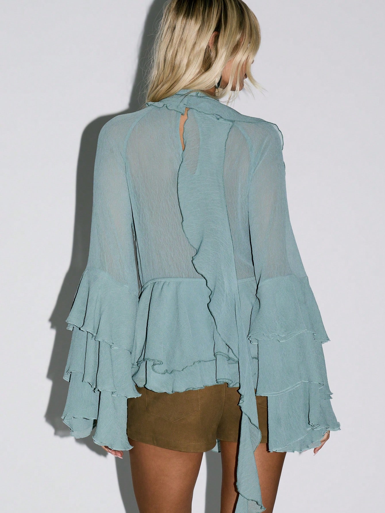 KIZN Ruffled High Neck Blouse With Bell Sleeves And Cutout Detail