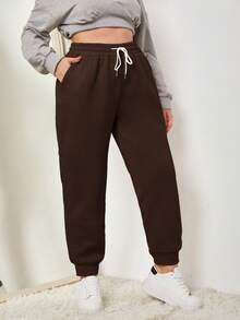 SHEIN EZwear Spodnie dresowe w jednolitym kolorze, z kieszeniami i ściągaczem w pasie w dużych rozmiarach