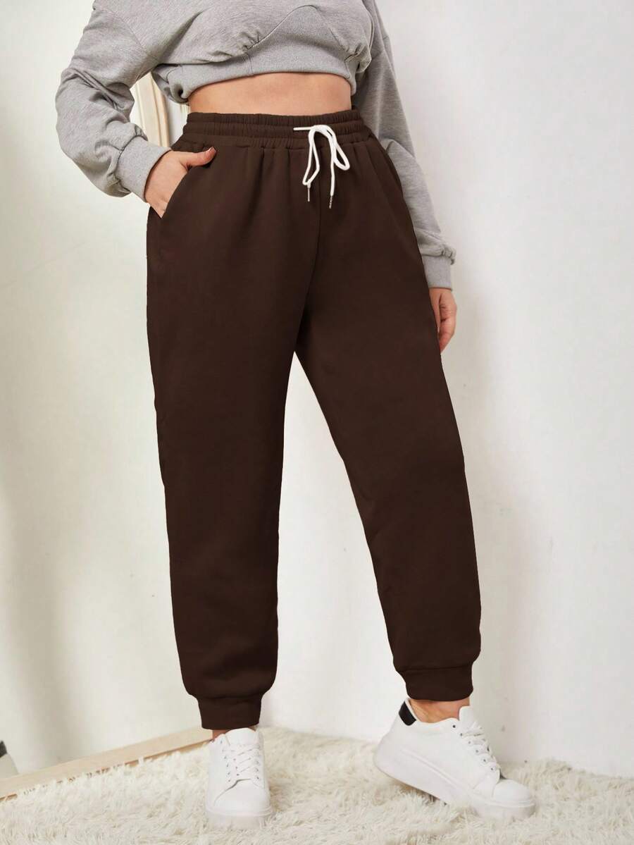 SHEIN EZwear Spodnie dresowe w jednolitym kolorze, z kieszeniami i ściągaczem w pasie w dużych rozmiarach