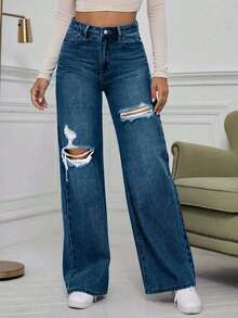 Jeans de pierna ancha con cintura alta y rotos en azul denim lavado