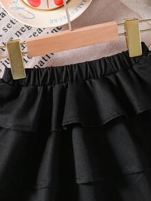 Emery Rose Kids Emery Rose Kids Váy xòe màu trơn phong cách Halloween thường ngày cho bé gái, phối đồ dạo phố, tối giản, thể thao, học viện, phù hợp với mọi mùa (xuân, hạ, thu, đông), mặc ở nhà, tập thể dục ngoài trời, đi học, giải trí hàng ngày. Cùng phong cách với mẹ tôi, cùng phong cách với chị gái và em trai tôi. Váy đen cho bé gái, váy đen xếp nếp nhiều tầng màu đen, váy xòe đen cho bé gái, váy đen trẻ em, váy ngắn màu đen kèm quần short, dài đến đầu gối, váy đen thu đông - màu đen - Xem 7
