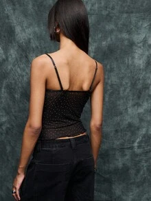 TypaGal La parte superior de corsé de malla de puntos transparente es la mezcla definitiva de alternativo y gótico, ideal para la ropa de mujer de otoño y Halloween. Combínalo con pantalones de pierna ancha o debajo de chaquetas para los corsés para mujer. Una opción elegante tanto para disfraces de Halloween como para ropa de invierno para mujeres que buscan un look audaz.