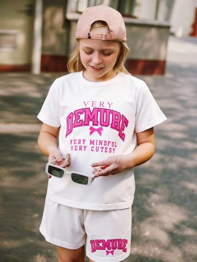SHEIN Explorewe 2pcs Tween Girl Outfit - Casual, Comfortable And Simple Cartoon Bow & English Letter Print Short Sleeve T-Shirt Matched With Black Sports Shorts Set, Suitable For Spring/Summer Daily Wear